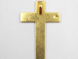 a close up of a gold cross on a white surface