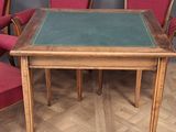 four chairs around a table with a green table top