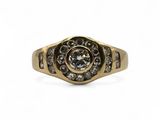 a close up of a gold and diamond ring on a white background