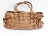 tan quilted leather handbag on a white background