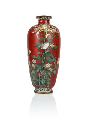 a red vase with a bird and flowers on it