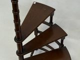 a spiral staircase made of wood on a white background