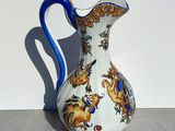 a white and blue vase sitting on a table