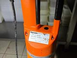 an orange machine that is sitting on the floor