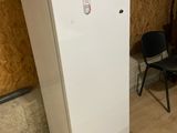 a white refrigerator with a microwave on top of it