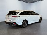 the rear end of a white car in a white room