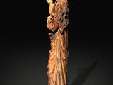 a wooden statue of a woman holding a baby in her arms
