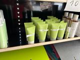 many bottles of lotion on a shelf in a store