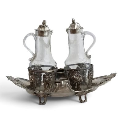 a silver plate with two silver vases on top of it