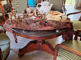 a table with many chairs and a vase on top of it