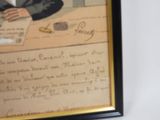 a picture of a man sitting at a desk with a pen in his hand