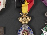 three medals are displayed on a black surface with a ribbon