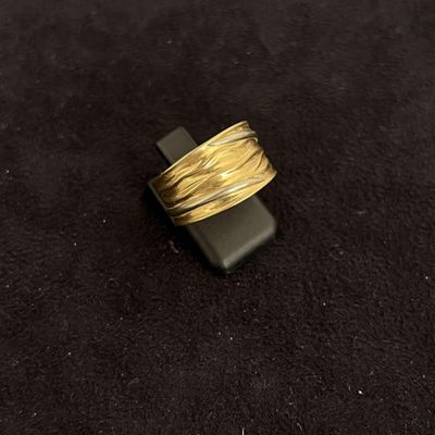 a close up of a gold ring on a black surface