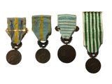 three medals are shown in a row on a white background