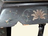 a black table with a floral design on it