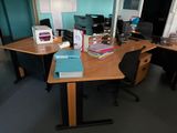 a desk with a lot of books and a computer on it