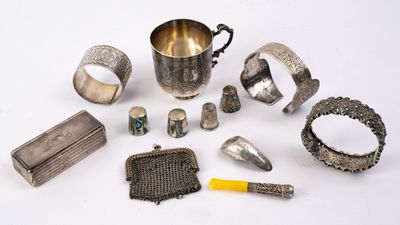 an assortment of silverware and other silverware items on a white surface