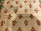 a white and green rug with a pattern on it