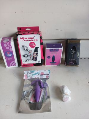a box of toothbrushes, a toothpaste, and other items on a table