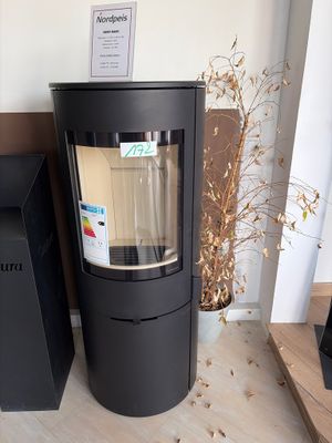 a black stove sitting next to a black trash can