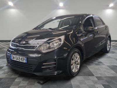the black car is parked on a checkered floor in the garage