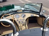 a view of a car driving down the street from the top of the car