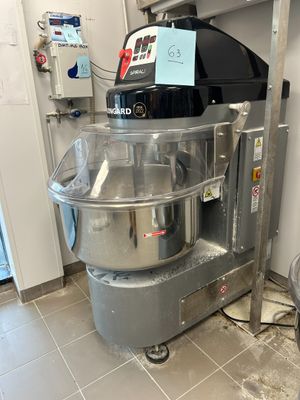 a machine that is sitting in a kitchen next to a trash can