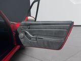a red car with its door open and the door handle open