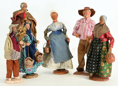 five figurines of people dressed in traditional clothing