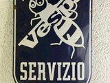 blue and white sign on a wall that says service with a picture of a man holding a wren