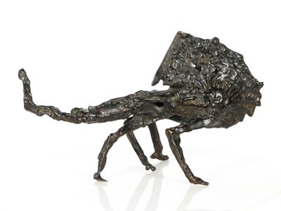 a bronze sculpture of a scorpion on a white surface