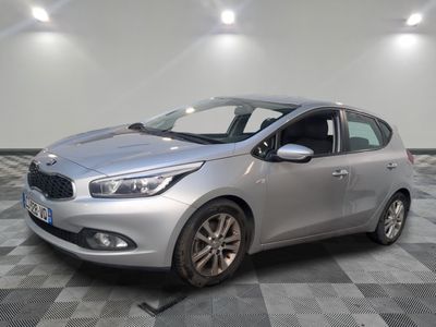 the silver car is parked on a checkered tile floor
