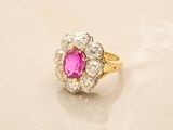 an image of a pink and white diamond ring on a marble surface