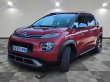 a red citrole is parked in a room with checkered floor
