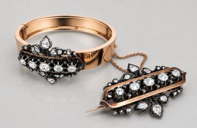 two rings and a brooch on a table