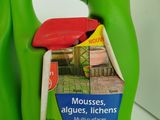 a bottle of mousses and a bottle of cleaner on a counter