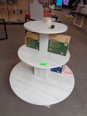 une table à trois étages sur laquelle est posée une tasse