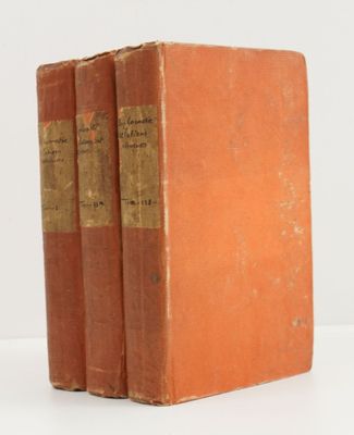three books sitting on top of each other on a white surface