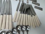 a lot of spoons and spoon knives on the table