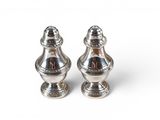 two silver salt and pepper shakers on a white background
