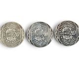 three different types of coins are shown on a white surface