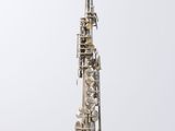 a silver saxophone with a silver body and silver keys