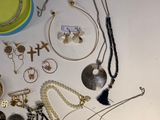 a lot of jewelry that is laying out on the table
