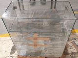 a glass display case with a cross on top of it