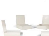 three white chairs and a table on a white surface