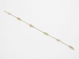 a gold chain bracelet with a white pearl bead on a white background