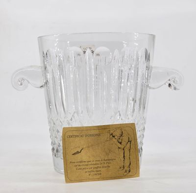 a clear glass vase with a gold label on it