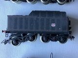 three different types of toy trains on a white surface