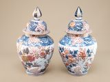 two blue and white vases sitting next to each other