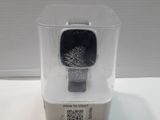 a plastic container with a watch inside of it